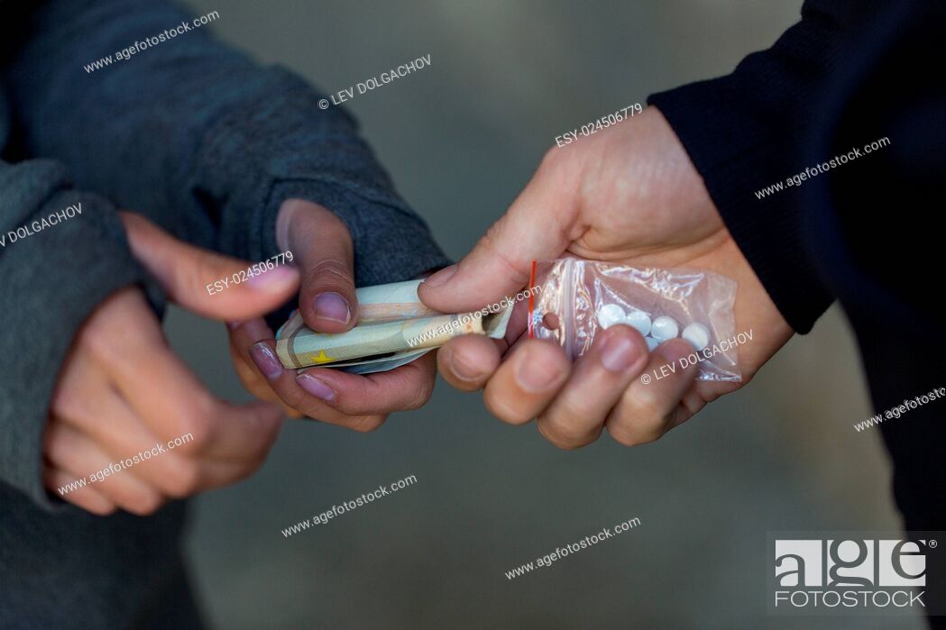Stock Photo: drug trafficking, crime, addiction and sale concept - close up of addict with money buying dose from dealer on street.