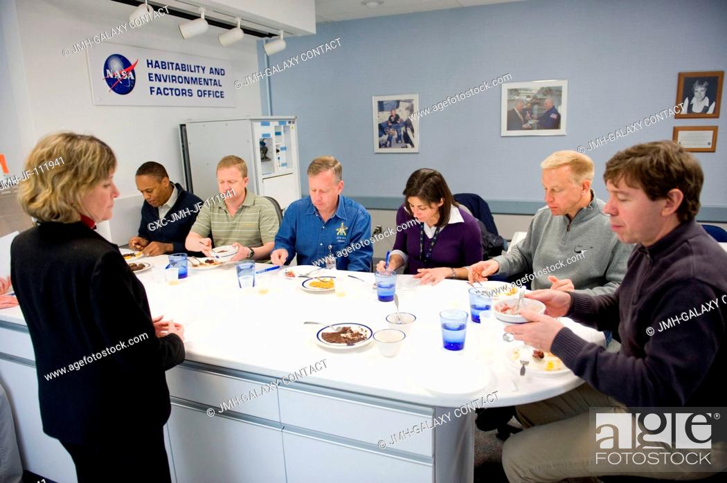 Stock Photo: STS-133 crew members participate in a food tasting session in the Habitability and Environmental Factors Office at NASA's Johnson Space Center.
