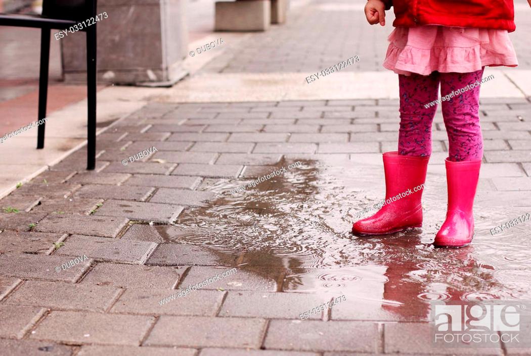 Stock Photo: Adorable 4 years old girl at rainy day in springtime.