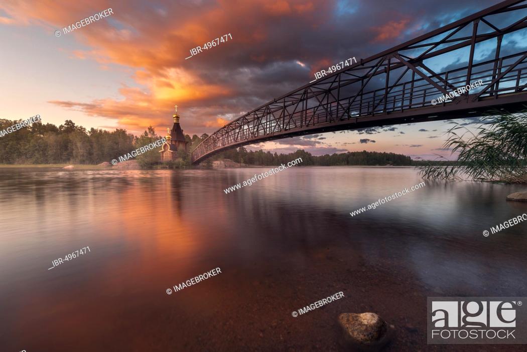 Stock Photo: Bridge and Church of St. Andrew at Vuoksi River during sunset, Vasilyevo, Leningrad region, Russia, Europe.
