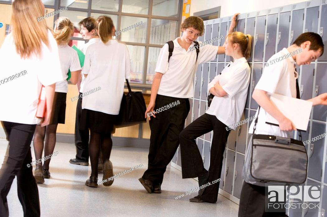 Stock Photo: Secondary school students in a school hallway.