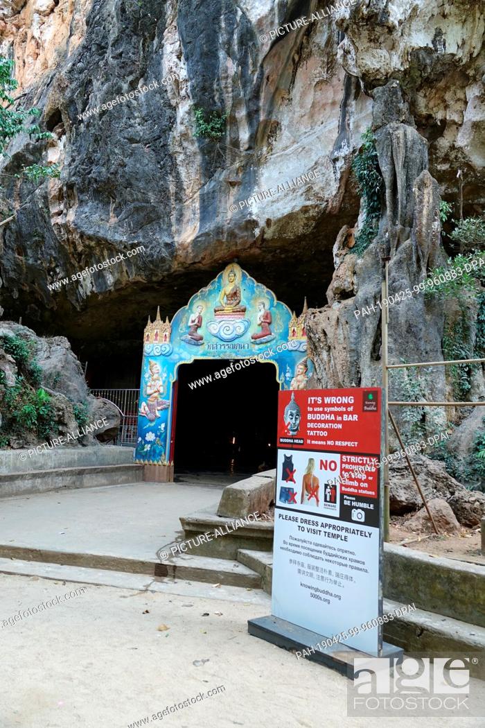 Stock Photo: 04 March 2019, Thailand, Takua Thung: The entrance to Wat Suwan Kuha, also called Wat Tham (""cave temple""). It belongs to a Buddhist temple complex in the.