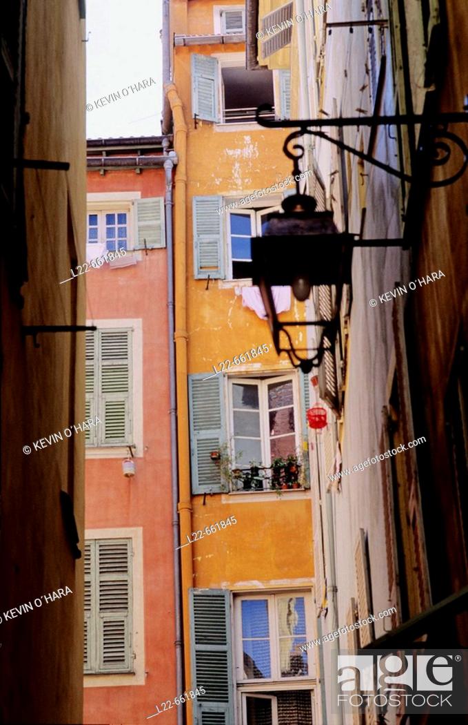 Stock Photo: The 'vieille ville' with narrow streets curving in irregular fashion between old buildings with red-tile roofs. City of Nice. Alpes-Maritimes.