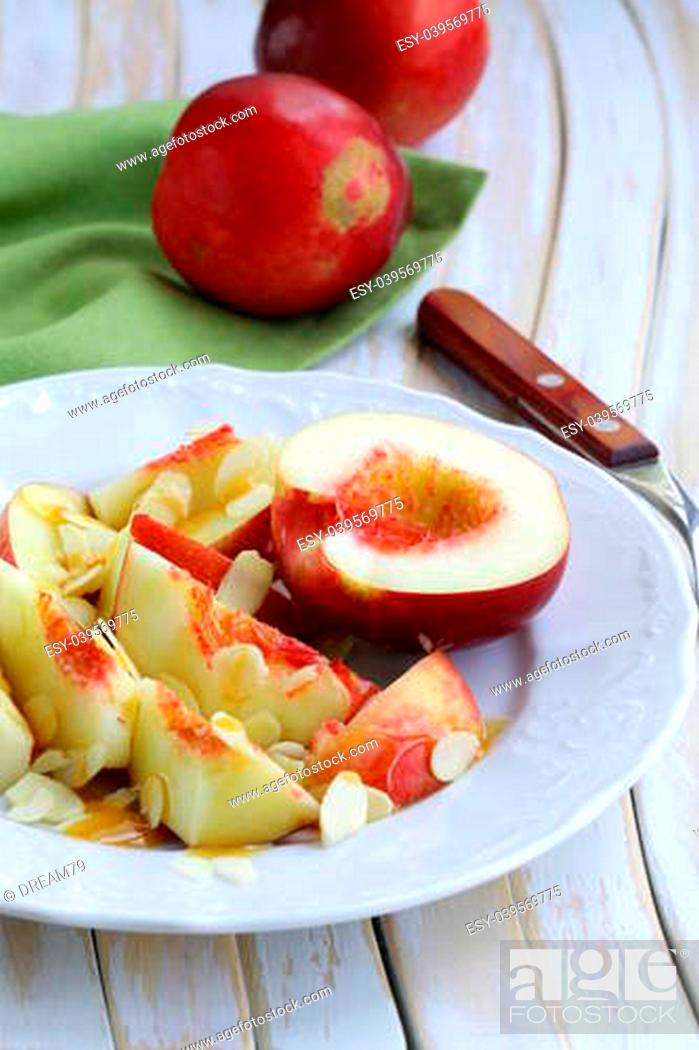 Stock Photo: Summer fruit dessert with peaches, almonds and honey.