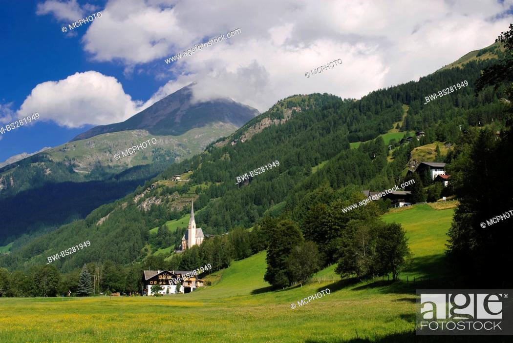 Stock Photo: pictoresque village with church at a mountain slope, Austria, Kaernten, Heiligenblut.