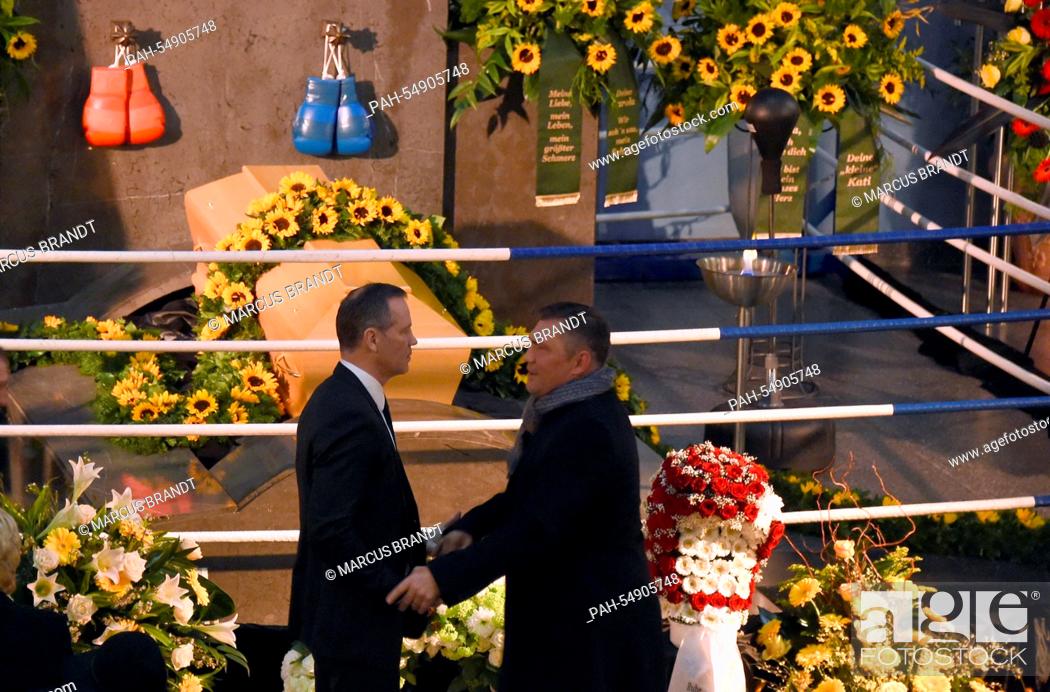 Stock Photo: Former boxing pros and world champions Dariusz Michalczewski (R) and Henry Maske shake hands during the funeral service of late boxing coach Fritz Sdunek in.