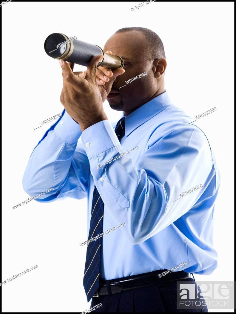 Stock Photo: Businessman looking through telescope.