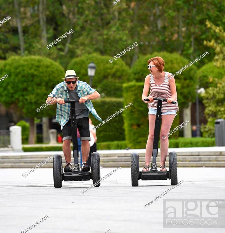 young happy tourist couple riding segway enjoying city tour in Madrid park  in Spain having fun..., Stock Photo, Picture And Low Budget Royalty Free  Image. Pic. ESY-035558548 | agefotostock