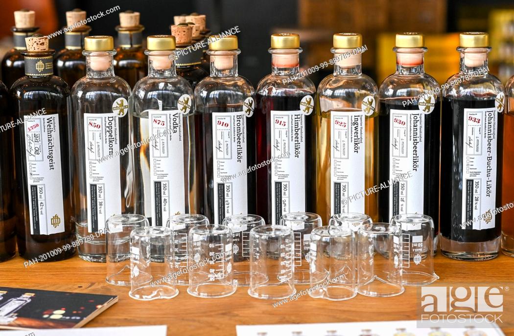 Stock Photo: 08 October 2020, Berlin: In the showroom of the Deutsche Spirituosen Manufaktur, bottles with various distillates and beakers are set up for tasting.
