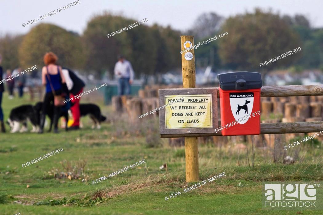 Stock Photo: 'Private Property', We Request All Dogs Are Kept On Leads' and 'Public Footpath' sign beside dog waste bin, Dunster Beach, near Minehead, Somerset, England.