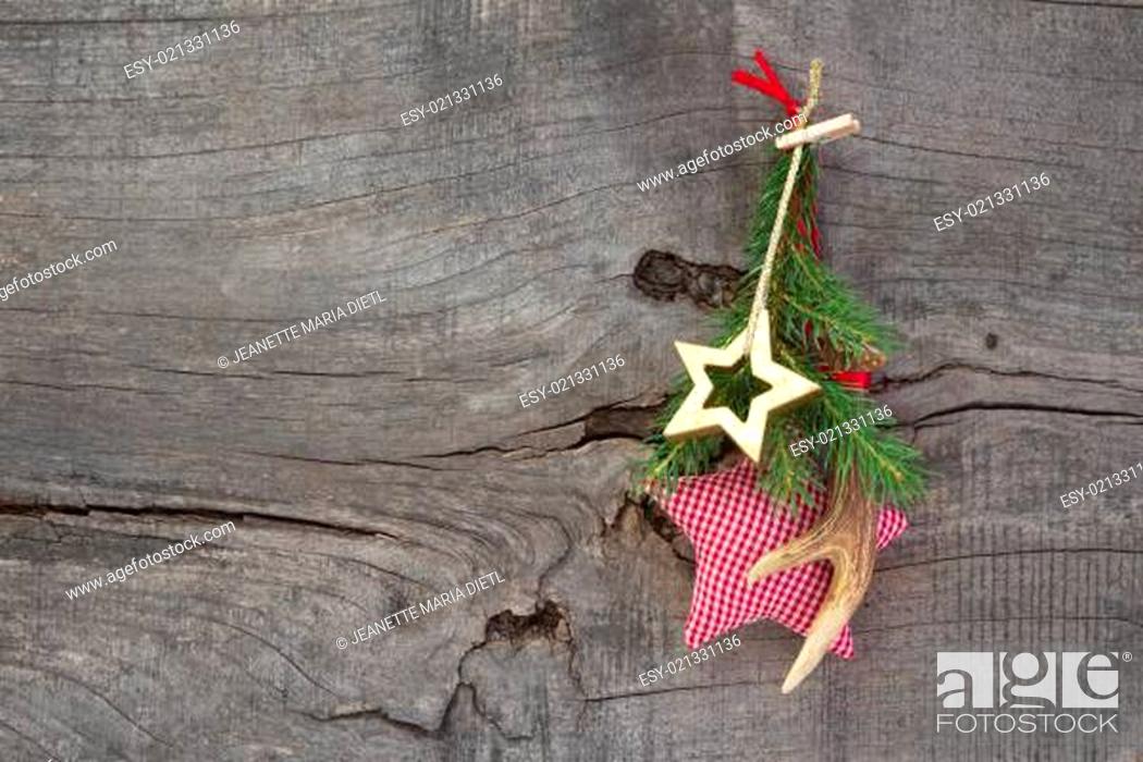 Stock Photo: Top view of christmas decoration with antler and checked star on wooden background.