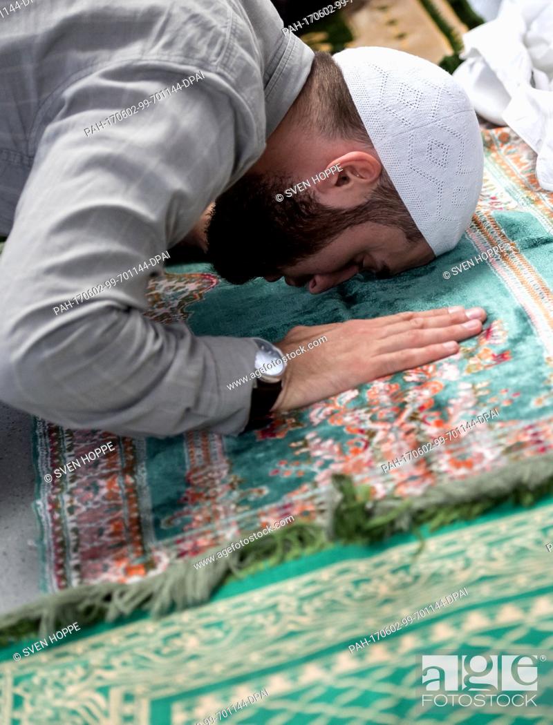 Stock Photo: A Muslim attends Friday prayers in the Munich Kammerspiele theatre in Munich, Germany, 02 June 2017. The Muslims are performing their prayer at the facility for.