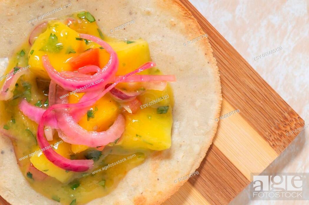 Stock Photo: Mango ceviche, vegetarian and vegan Mexican food. Fresh fruit seviche close up on fried corn tortilla.