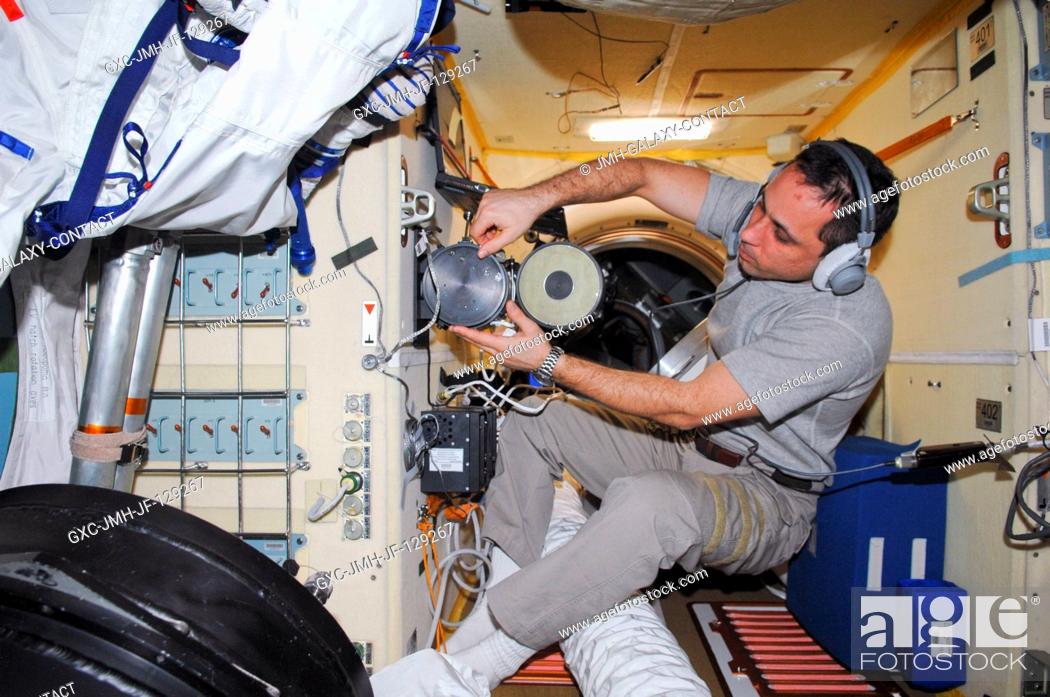 Stock Photo: Russian cosmonaut Anton Shkaplerov, Expedition 30 flight engineer, conducts an active session for the Russian experiment KPT-10 Kulonovskiy Kristall (Coulomb.