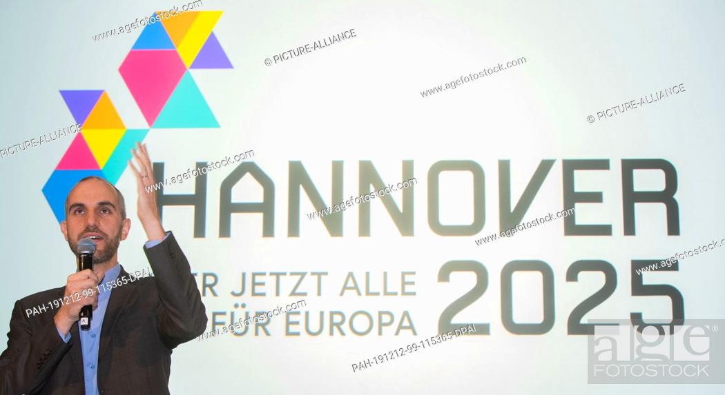Stock Photo: 12 December 2019, Lower Saxony, Hanover: Belit Onay (Grüne), Lord Mayor of the City of Hanover, speaks in front of a lettering ""Hannover 2025"" in the New Town.