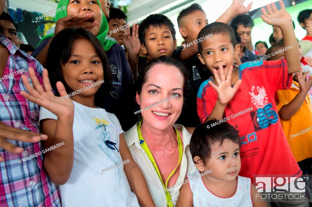 Stock Photo: Actress Natalia Woerner (C) poses with former street children in Jakarta,  Indonesia, 03 November 2014. She supports Kindernothilfe.