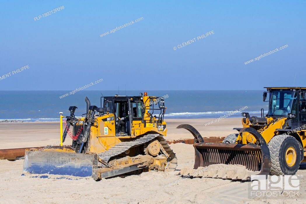 Stock Photo: Bulldozers used for sand replenishment / beach nourishment to make wider beach to reduce storm damage to coastal structures along the Belgian coast.