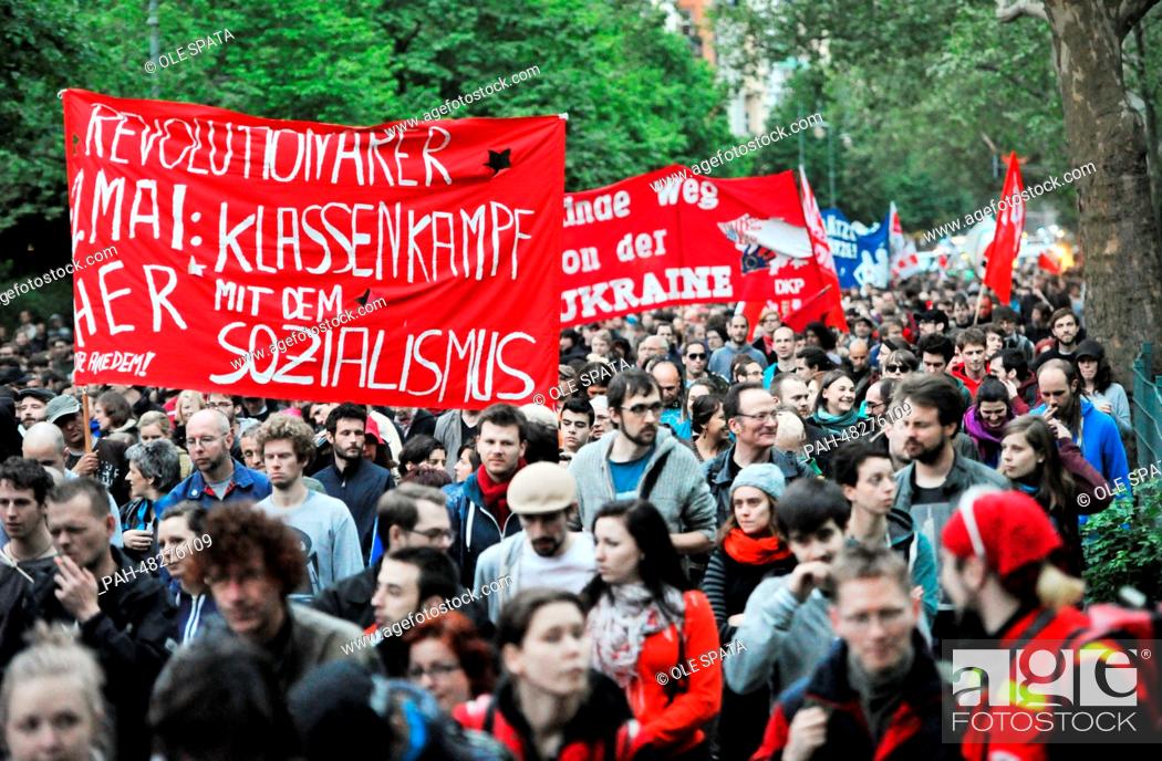 Stock Photo: People take part in the May Day demonstration with a banner reading ""Rvolutionary May 1: Class Battle - Give us socialism"" in Berlin-Kreuzberg, Germany.