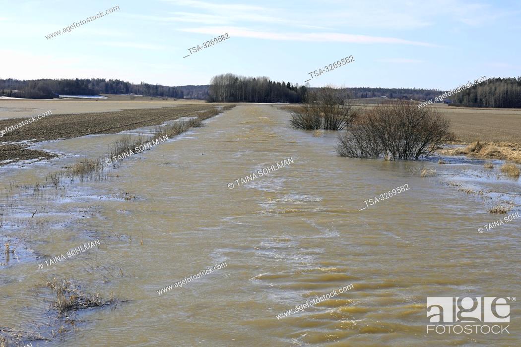 Stock Photo: Tuohittu, Salo, Finland. March 24, 2019. Spring flooding of Muurlanjoki river onto fields in Tuohittu, Southwest of Finland.