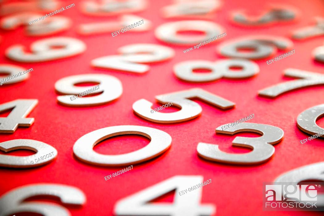 Stock Photo: Mathematics background made with solid numbers on a board. Isolated on red.