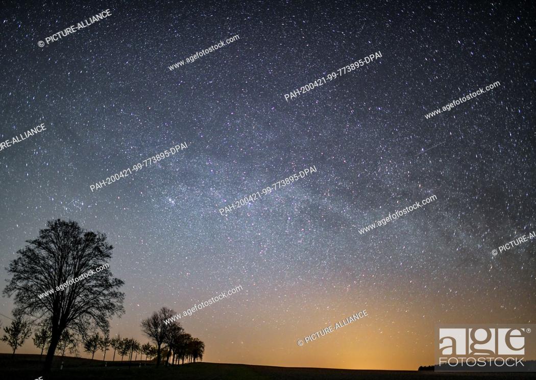 Stock Photo: dpatop - 20 April 2020, Brandenburg, Petersdorf: The starry sky shines over the landscape at night. Mostly starry skies allow an unobstructed view of the.