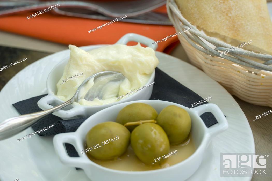 Stock Photo: Allioli- homemade traditional Spanish garlic dip and olives appetizer on table of restaurant Alicante Spain.