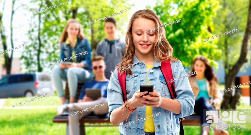 Stock Photo: teen student girl with school bag and smartphone.