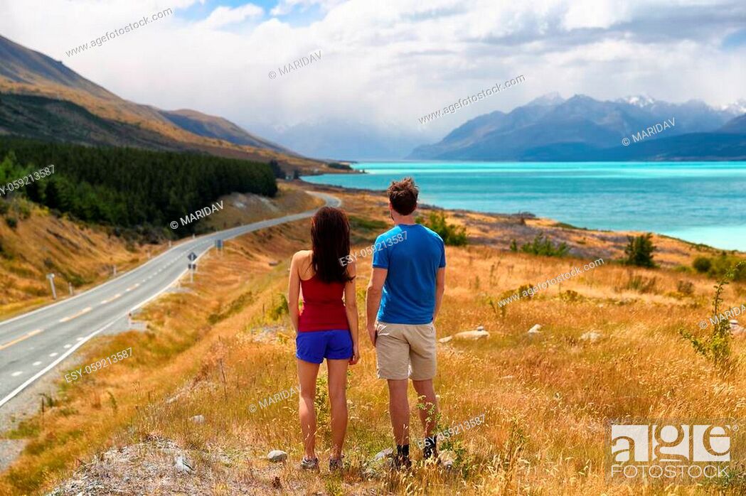 Stock Photo: New Zealand travel nature couple tourists looking at view of Aoraki/Mount Cook at Peter's lookout, famous tourist destination.