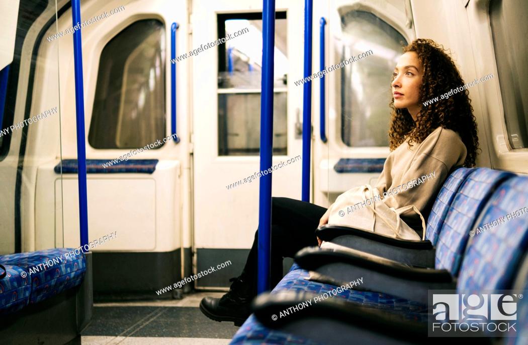 Stock Photo: Contemplative woman sitting in subway train.