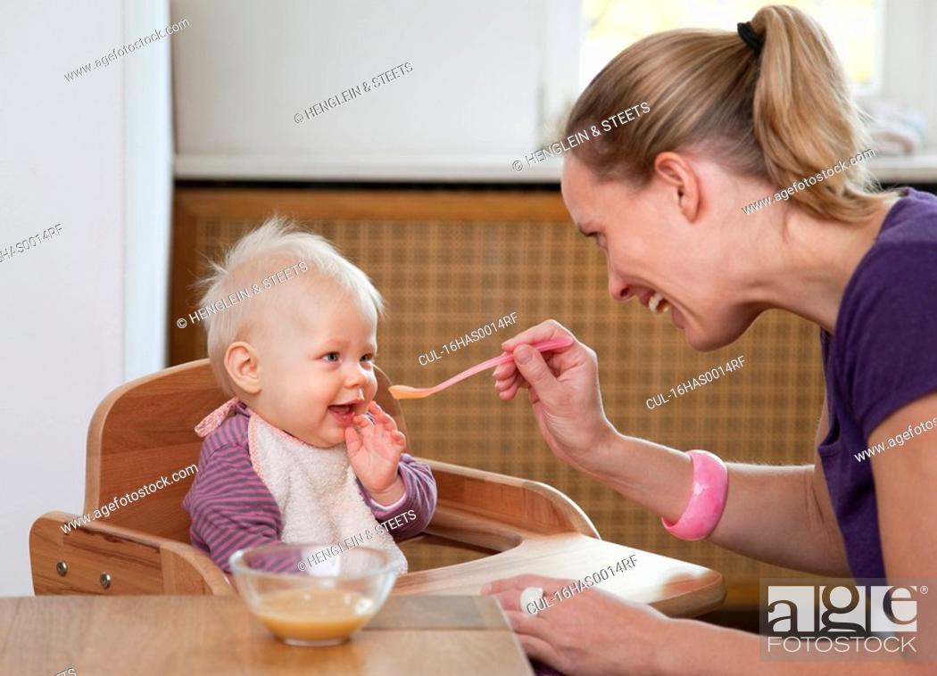 Stock Photo: mother feeding baby.