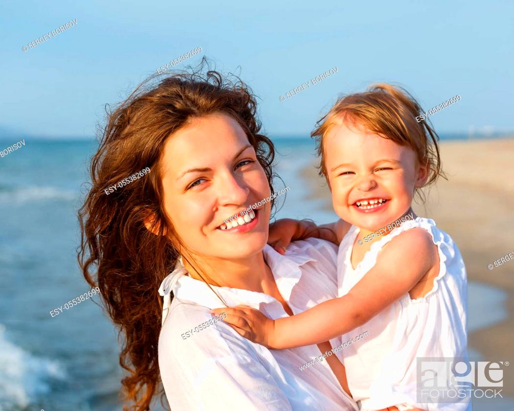 Stock Photo: Portrait of mother and little daughter on the beach.