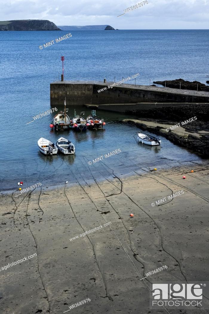 Stock Photo: High angle view of fishing boats moored in harbour at low tide.