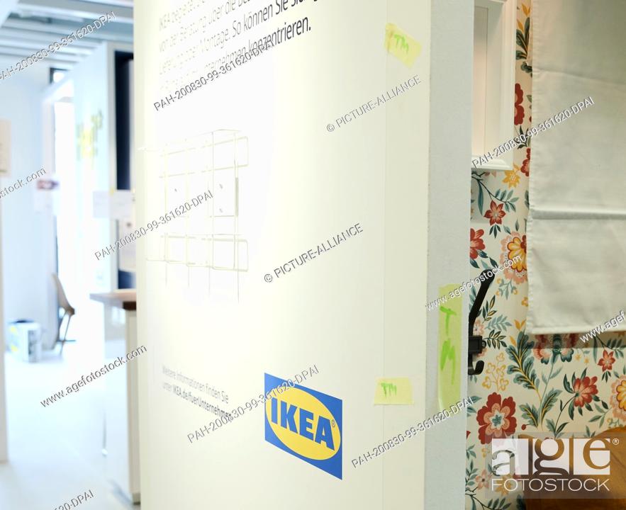 Stock Photo: 28 August 2020, Berlin: Crepe tape with memorial letters is still sticking to the walls of an XS Ikea store. On 1.9. a miniature edition of the Ikea furniture.