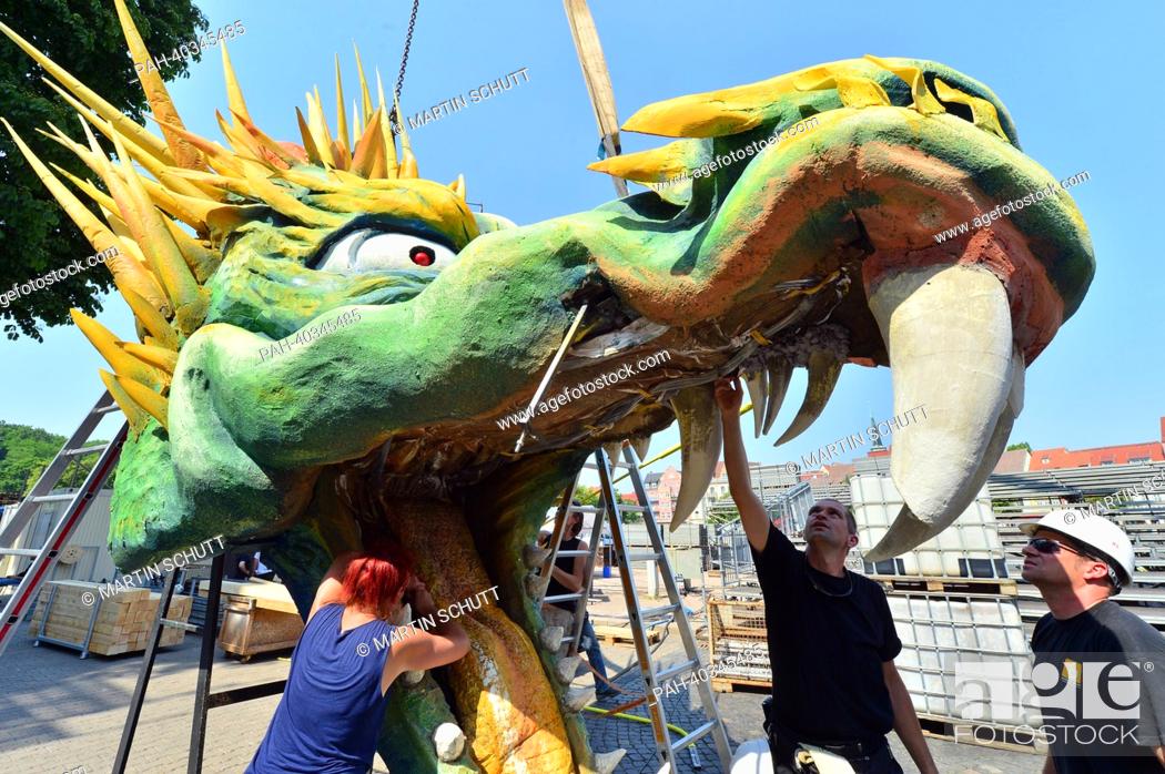 Stock Photo: The stage design with an oversize dragon head for the opera festival Domstufen-Festspiele is constructed at the Domplatz in Erfurt, Germany, 19 June 2013.