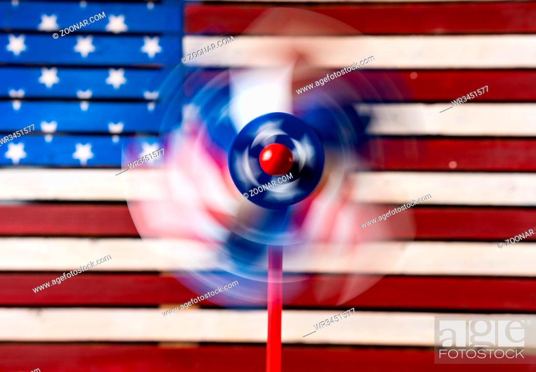 Stock Photo: Independence day concept with pin wheel or whirligig in front of a USA Flag.