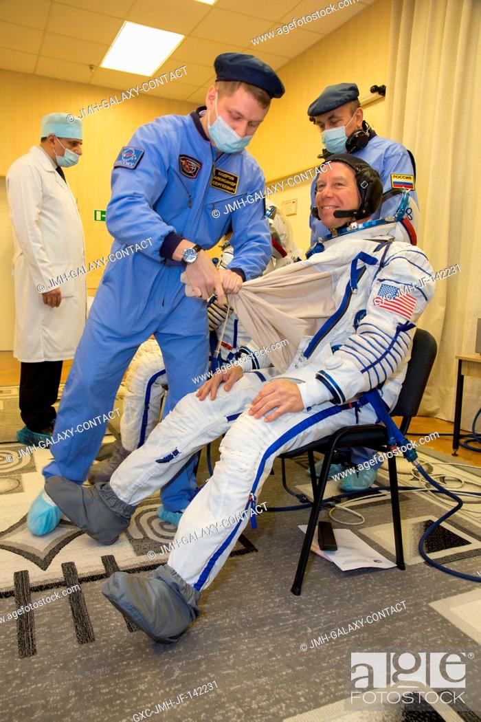 Stock Photo: In the Integration Facility at the Baikonur Cosmodrome in Kazakhstan, Expedition 46-47 crewmember Tim Kopra of NASA suits up during a fit check dress rehearsal.