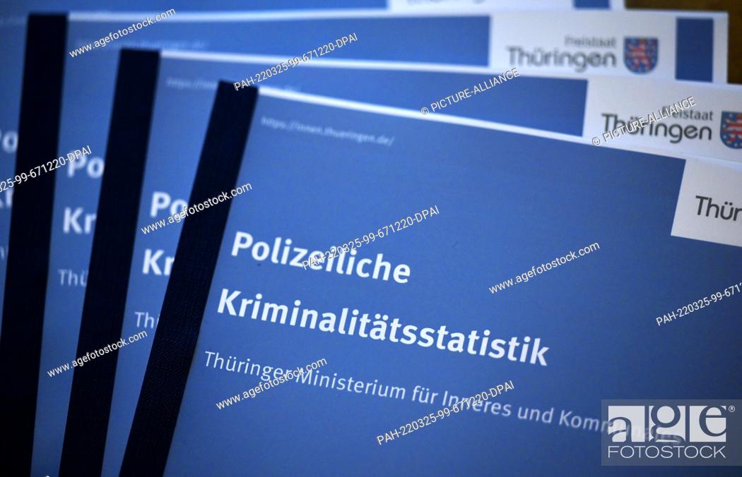 Stock Photo: 25 March 2022, Thuringia, Erfurt: Copies of the police crime statistics lie on top of each other at a press conference to present the police crime statistics.