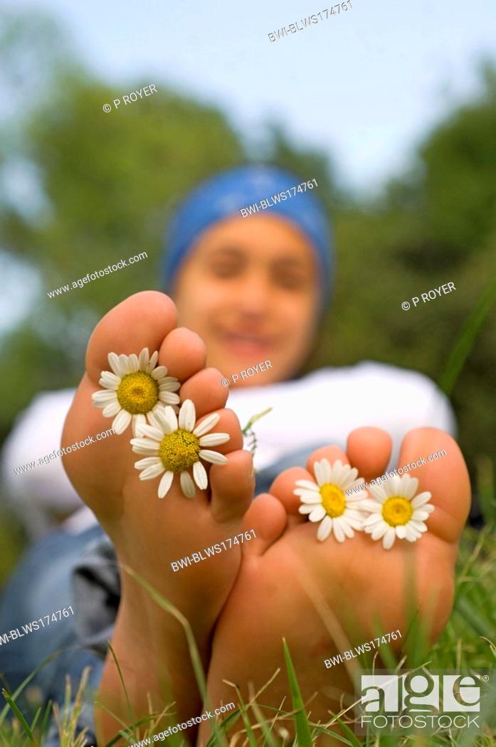 Stock Photo: feet with flowers between the toes.