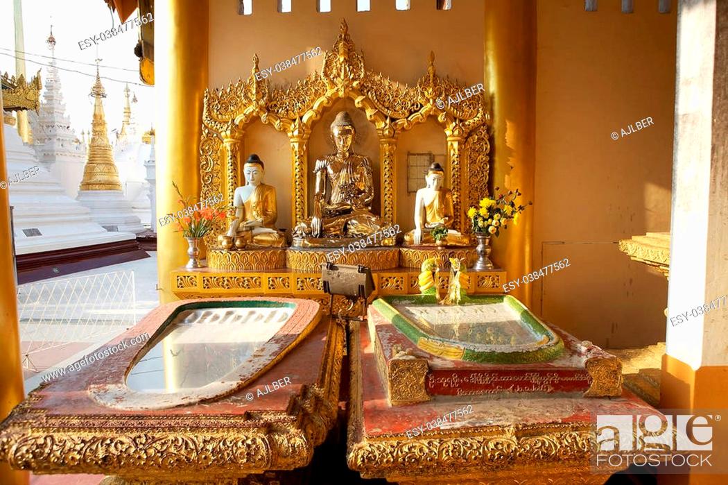 Stock Photo: Buddha images at the Shwedagon Pagoda is a gilded stupa located in Yangon, Myanmar. The 99 metres tall pagoda is situated on Singuttare Hill.