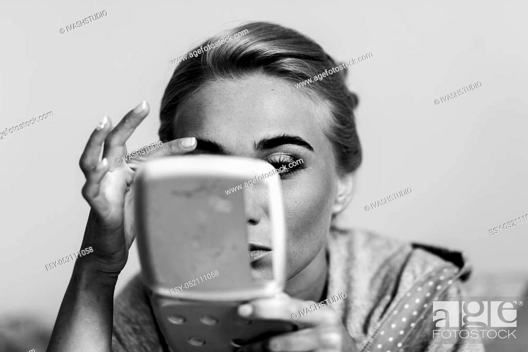 Stock Photo: Fabulous lady adjust her brows doing a meke up.