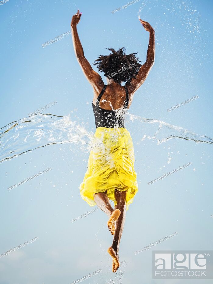 Stock Photo: Water spraying on black woman ballet dancing.