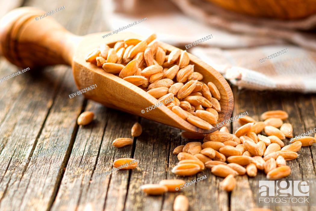 Stock Photo: Healthy spelt grains in wooden scoop.