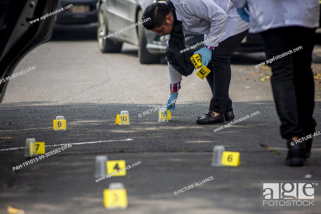 Stock Photo: 25 September 2019, Mexico, Mexiko-Stadt: A forensic expert collects evidence after the death of two people in a clash between two criminal organizations in.