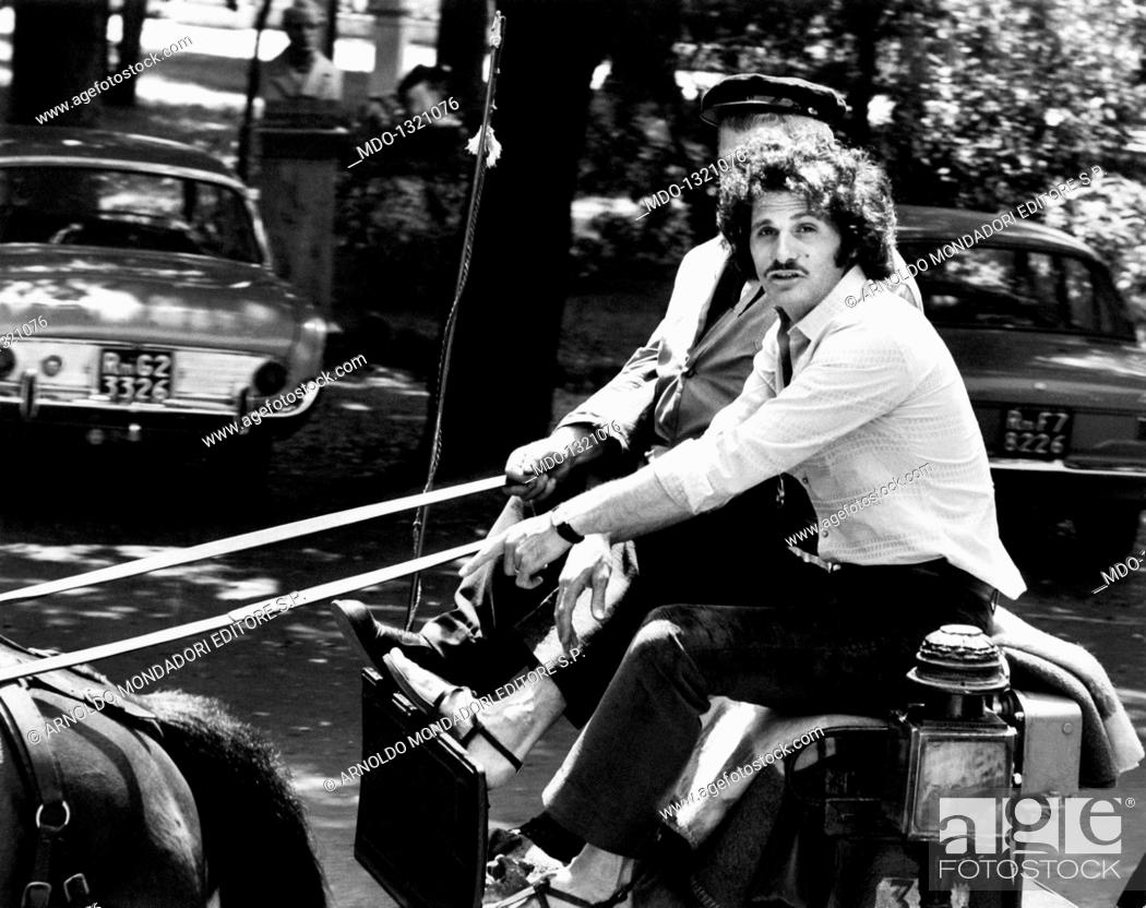 Stock Photo: Tony Musante on a cart. The American actor Tony Musante (Anthony Peter Musante) travelling on a cart. Rome, 1970s.
