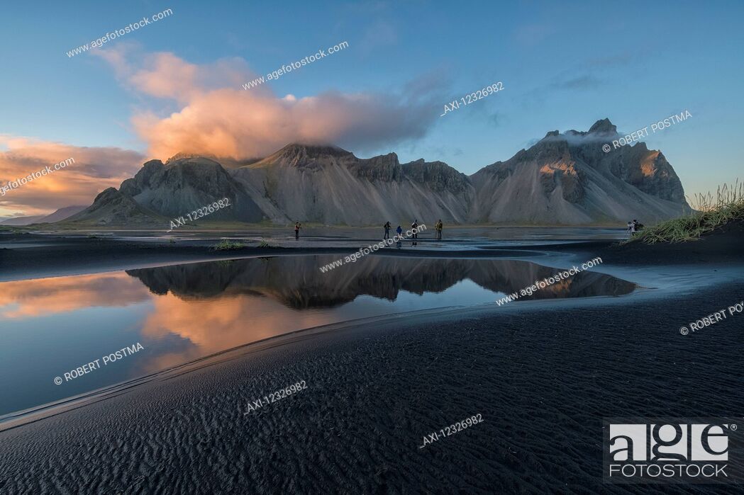 Stock Photo: People photographing the beautiful landscape of Stokknes or Vestrahorn at sunset along the southeast coast of Iceland; Iceland.