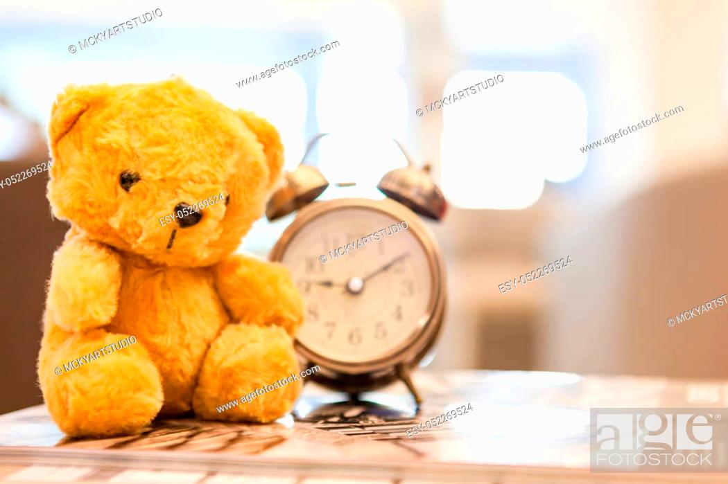 Stock Photo: Retro Teddy Bear toy alone with alam clock in lunch time on vintage wall background.