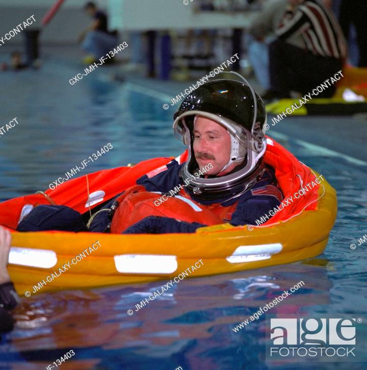 Stock Photo: Astronaut Kent V. Rominger, mission commander, has just deployed his life raft during emergency bailout training with his STS-96 crew mates.