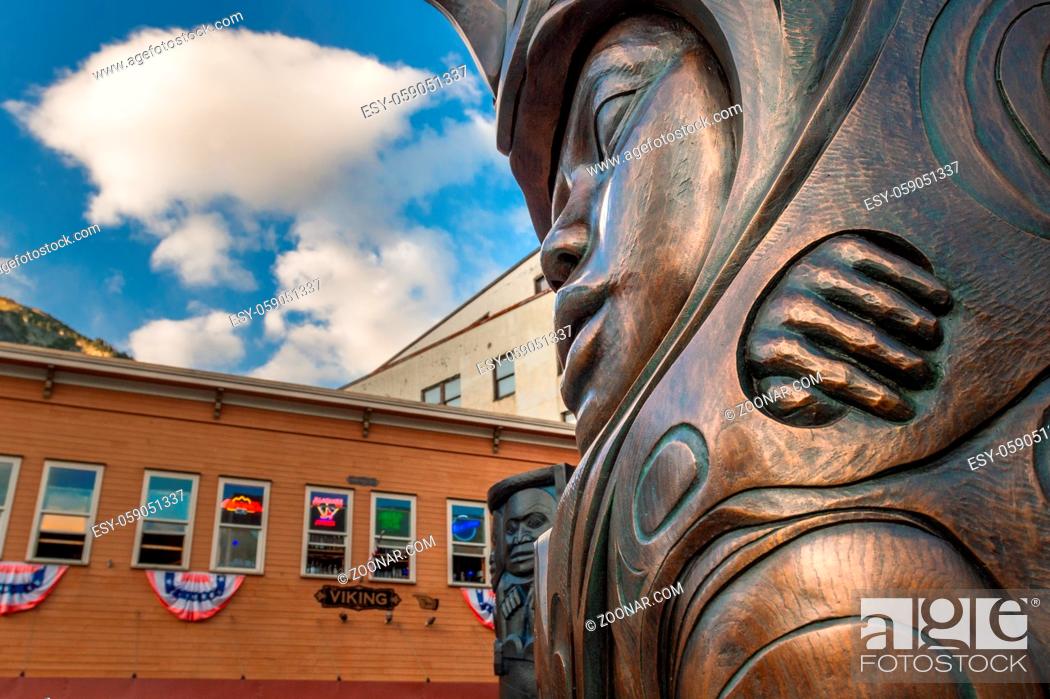 Stock Photo: September 14, 2018 - Juneau, Alaska: Bronze sculpture of woman and raven by Tlingit Native artist Stephen Jackson in front of the Walter Soboleff Building at.