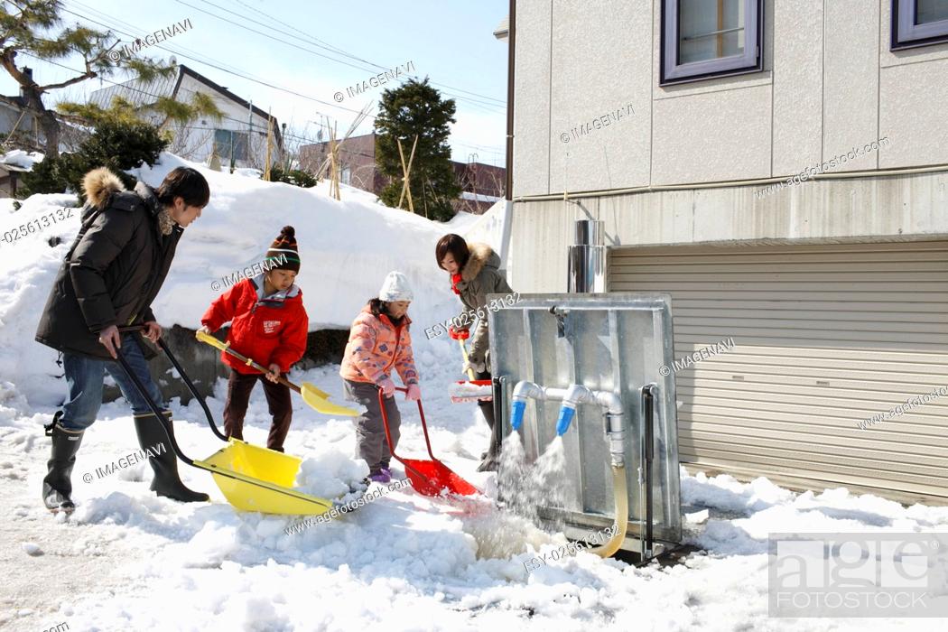 Stock Photo: Family removing snow.