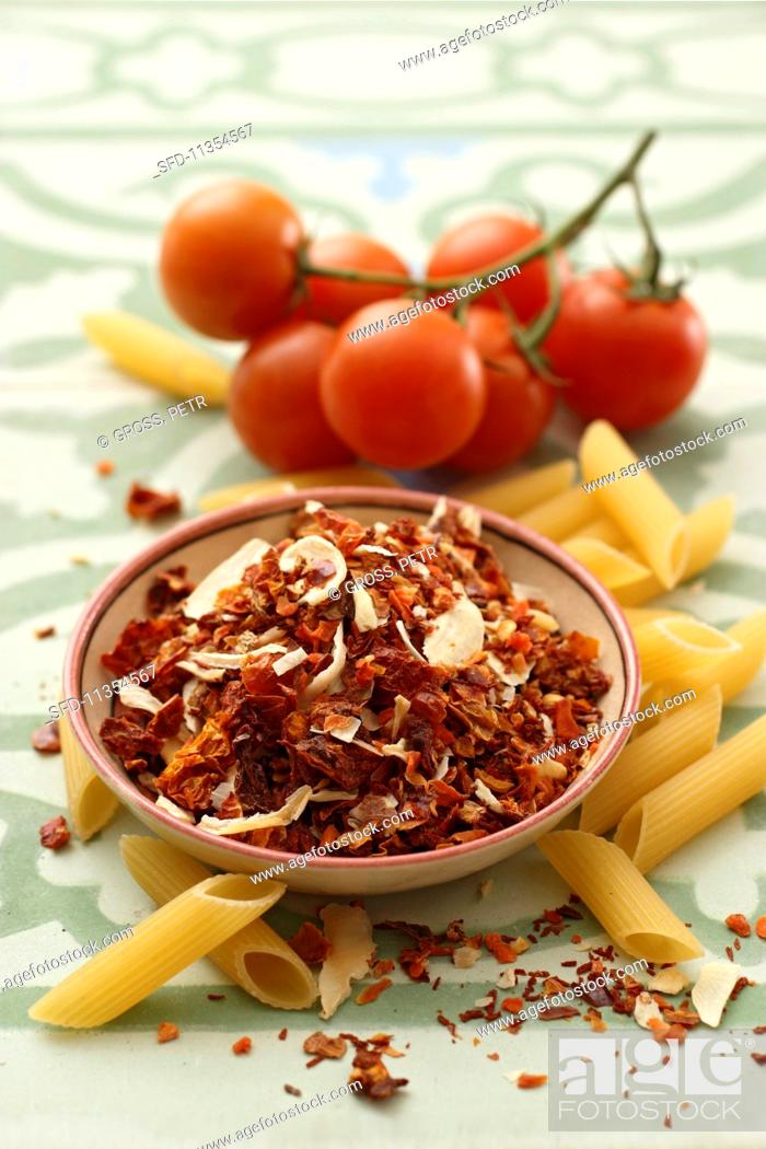 Stock Photo: Arrabiata spice mixture, penne and fresh tomatoes.